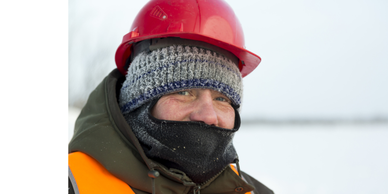 Worker wearing protective outdoor gear for the winter